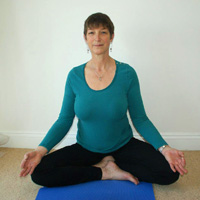 Cathie in easy seated pose – often used in meditation. Hands in chin mudra (hand gesture with thumb and index finger touching and palm up) representing the union of individual self with Universal Self.